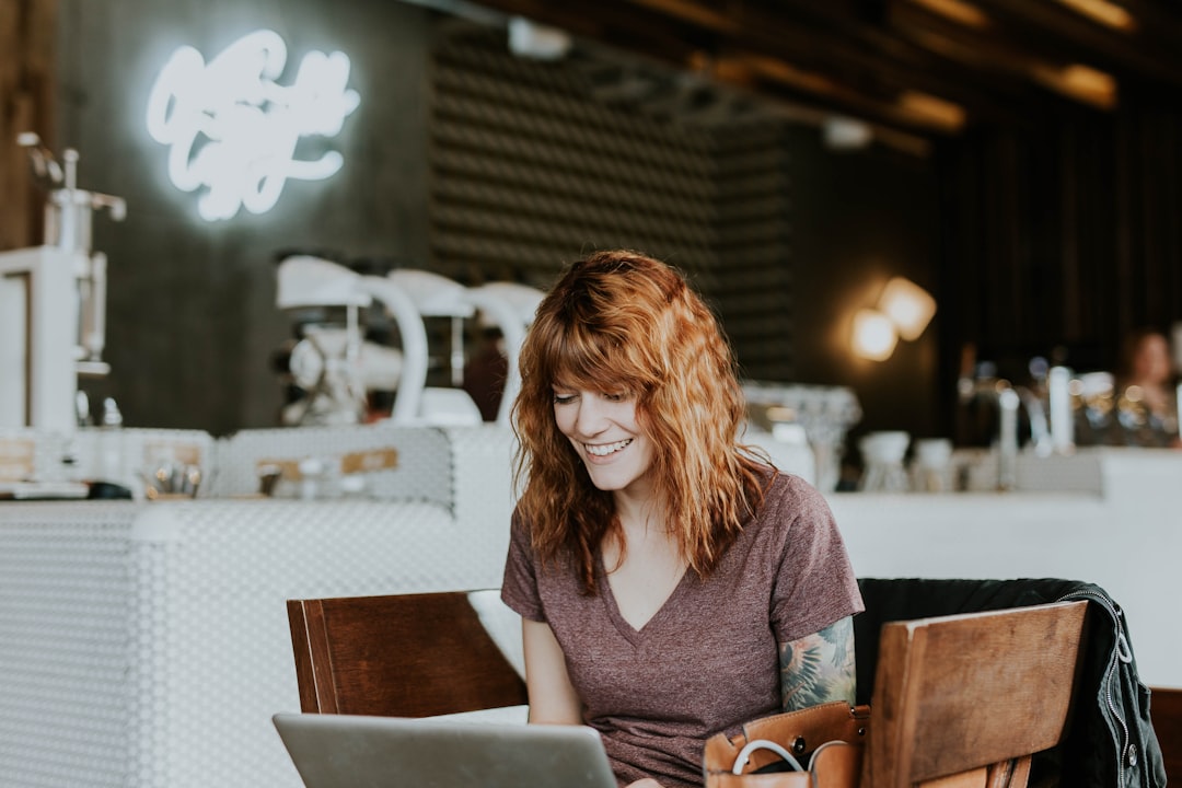 small business owner using AI on laptop in modern office